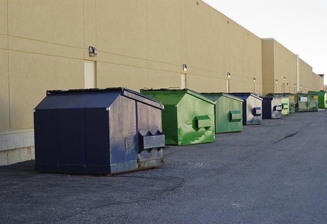 heavy-duty roll-off dumpsters outside a construction zone in Cinebar